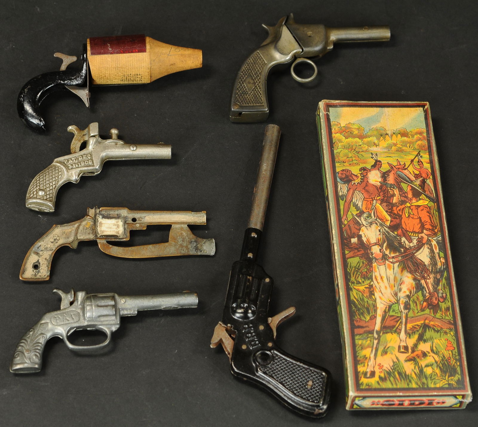 LOT OF FIVE CAP GUNS: 1594. LOT OF FIVE CAP GUNS | Gip, Rip and Sid 12 w/ box with partial pattern's. | 9" l. | (VG - Exc. Cond.) | $200 - $400