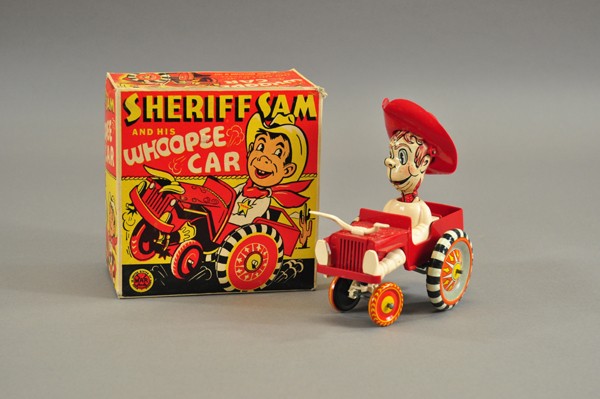 BOXED SHERIFF SAM WHOOPEE CAR: Marx wind-up car features cowboy in jeep with lithographed tin head and wheels, everything else plastic. Old store stock. 6 1/2" l.