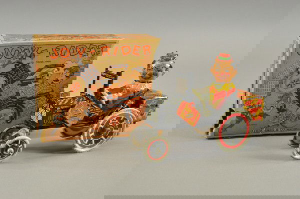 JOY RIDER WITH PARTIAL BOX: Louis Marx, lithographed tin, familiar seated figure with spinning head, suitcase at side of hood, trunk on rear, key wind operated. 8" l.