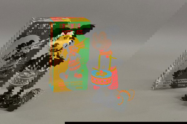 DRUMMING MICKEY MOUSE B/O WITH ORIGINAL BOX: Japan, Linemar, copyright Walt Disney Productions, tall figure of Mickey holds drum and sticks, cloth covered body, tin face and shoes, remote controlled lighting eyes and drum playing. 10 1/2" h.