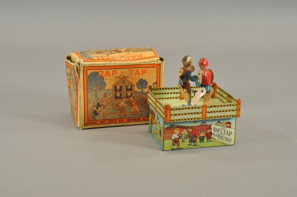 RAP & TAP BOXERS WITH BOX: Unique Art Mfg., lithographed tin, well detailed toy depicts boxing ring with two battling boxers at center, key wind operated. 5 1/2" h.