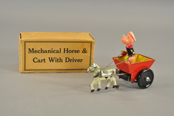 BOXED POPEYE MECHANICAL HORSE & CART: Louis Marx Co., celluloid figure of Popeye stands in open horse drawn lithographed tin wagon with barrel spring key wind action. 7 1/2" l.