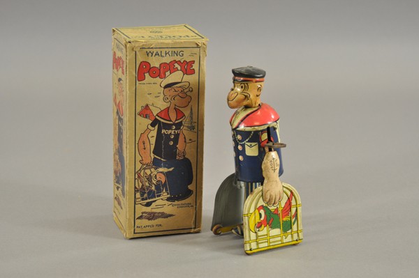 POPEYE WITH PARROT CAGES: King Features Synd., Louis Marx, lithographed tin, depicts walking Popeye holding parrot cages in hand, key wind operated. 7 1/2" h.
