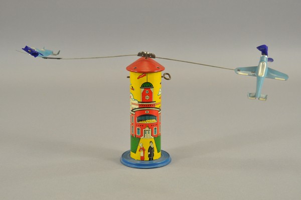 WIMPY AND CHARACTERS FLYER: Louis Marx but unmarked, lithographed tin tower as used on Popeye Flyers, same graphics but with red top, small blue base and circling airplanes overhead without pilots, key wind driven. A scarce vari