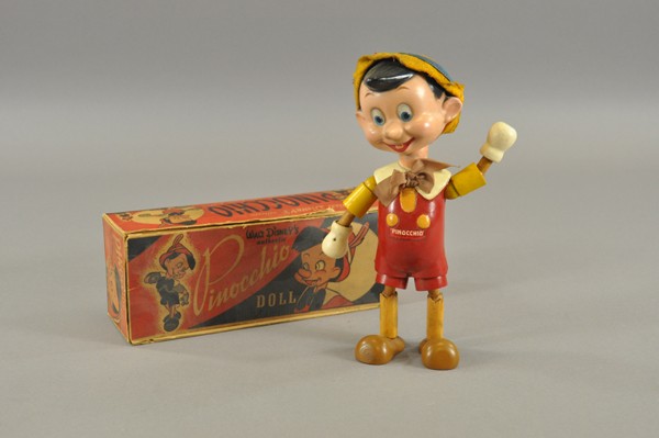 IDEAL PINOCCHIO FLEX DOLL WITH BOX: Wood figure of Walt Disney's famous character, composition head, jointed arms and legs, silk bow. Circa 1940. 11" h.