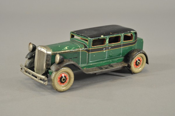 JAPANESE TOMIXA SEDAN: Made of wood with tin fenders, nickel grille, clockwork mechanism, very scarce example, styled in a Franklin type body, tin litho wheels. 11" l.