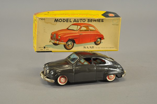 1960'S SAAB SEDAN WITH BOX: Bandai, Japan, lithographed tin, dark grey body, colorful tin litho seating and hubs, friction powered. 8" l.