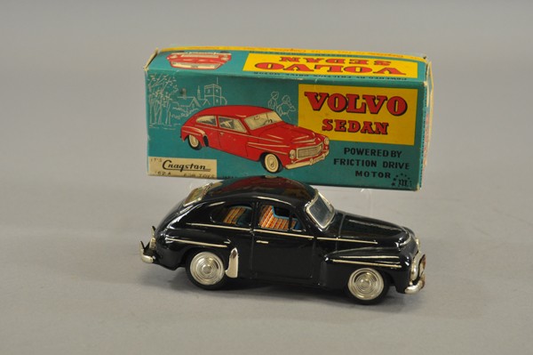 VOLVO SEDAN WITH BOX: Cragstan, Japan, lithographed tin, done in black body, nickel trim, tin litho seating, nickel hubs, friction driven. 8" l.