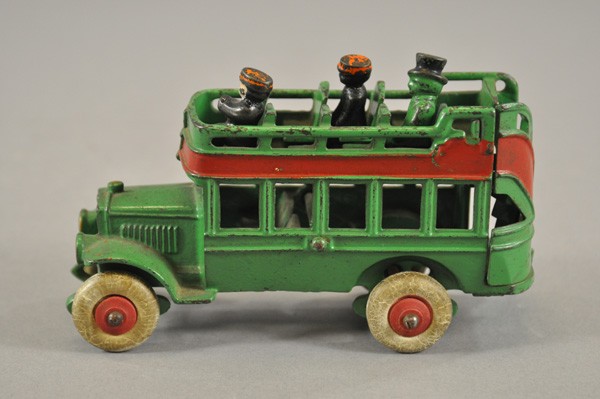 KENTON CITY BUS: c. 1930's, cast iron, painted in green overall, red side stripe, features three original figures, cast upper deck seating, rubber tires. 6 1/4" l.