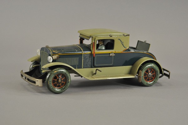 DISTLER COUPE WITH RUMBLE SEAT: Germany, c. 1930's, lithographed tin, done in blue body, olive roof and fenders, features electric lights, opening rumble seat, clockwork mechanism, seated driver. Provenance: Gottschalk Collection. 1