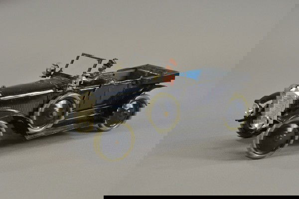 KARL BUB CABRIOLET: Germany, c. 1927, scarce example, done in blue body, features nickel grille, seated driver, dummy lights and side lanterns, clockwork mechanism, disc wheels. 13" l.