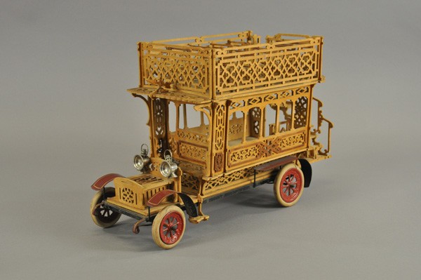 DOUBLE DECKER FRETWORK BUS: Possibly English, incredible detail to full stairway and upper deck seating, features metal chassis and fenders, rubber tires on spoke wheels, even nickel lamps. 20" l.