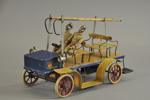 HOOK & LADDER TRUCK: Germany, attributed to Carette, c. 1900, well detailed and painted in simulated wood body, features open bench seating, containing two original figures, ladder on body supports, German crest decal on 