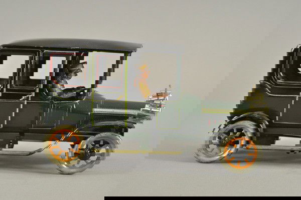 BING LIMOUSINE: Germany, c. 1920's. lithographed tin, green body with black roof, maroon window trim, head lamps, seated driver, clockwork mechanism, opening doors, a luxury model. 11 1/2" l.