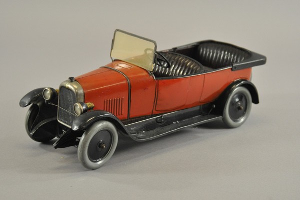 CITROEN B14 TORPEDO: France, c. 1927, tin plate auto, painted in red body, embossed seating done in black, electric headlights, spare on rear, clockwork driven. 15 3/4" l.