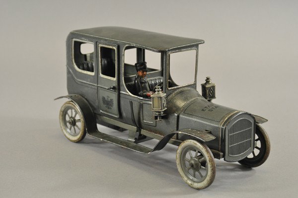 BING "ETAPPEN STATION" MILITARY SEDAN: Germany, produced prior to WWI, scarce, lithographed tin, grey body, opening passenger doors, seated driver, lettered hood, side lanterns, spoke wheels, clockwork driven. 12 1/2" l.