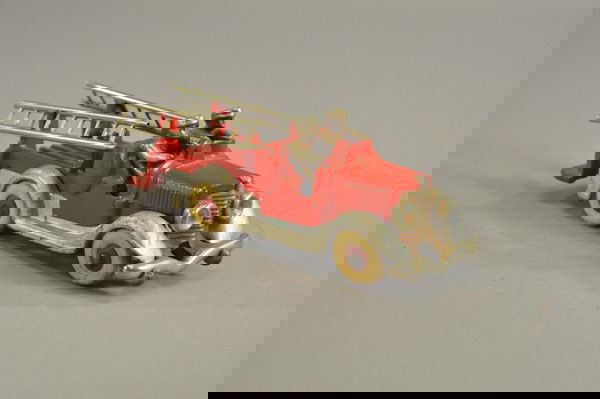 HUBLEY LADDER FIRE TRUCK: c. 1930's, cast iron, open bench seat and service bed, features ladder supports with nickel ladders, separate cast chassis painted in silver, nickel drivers and grille, rubber tires. 8 1/2" l.