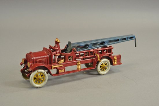 KENTON WATER TOWER FIRE TRUCK: Cast iron, red, open bench seat cab and service body, features blue tower which is raised by side crank, nice details to accessory castings on sides, spoke wheels. Scarce example. 16" l.