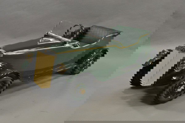 TRIANG MG PEDAL CAR: England, fiberboard and metal body, painted in green body, deep green fenders, upholstered seating, disc wheels, early open roadster styling, spare mounted on trunk, carefully crafted by restorer to r
