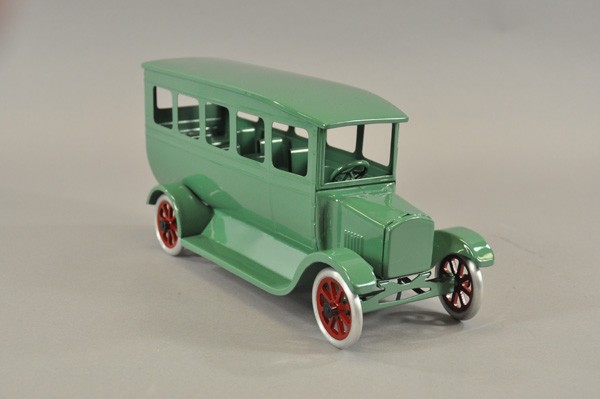 COWDERY FLIVVER BUS: Pressed steel, beautiful turquoise colored example, spoke wheels have red centers. 16" l.