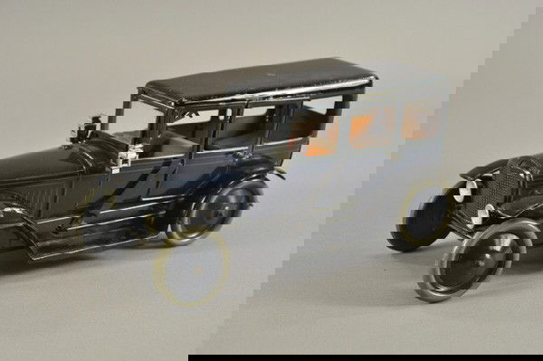 KARL BUB LIMOUSINE: Germany, c. 1926, lithographed tin, dark blue body, black roof, seated chauffeur, opening center doors, disc wheels, clockwork driven. 12" l.