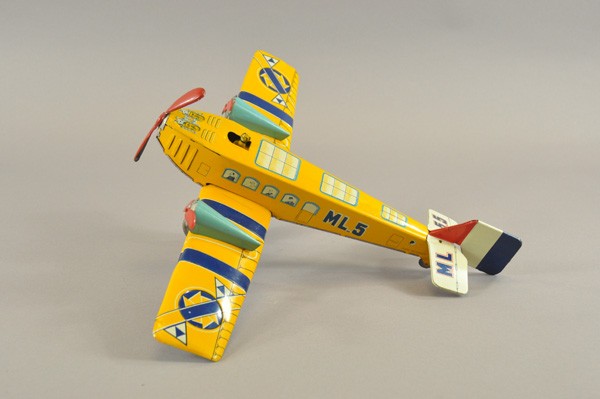 FRENCH PASSENGER PLANE: France, lithographed tin, bright yellow fuselage and wing, features tri-props, blue motors, red props, seated pilot, key wind barrel spring mechanism. 19 1/2" wingspan.
