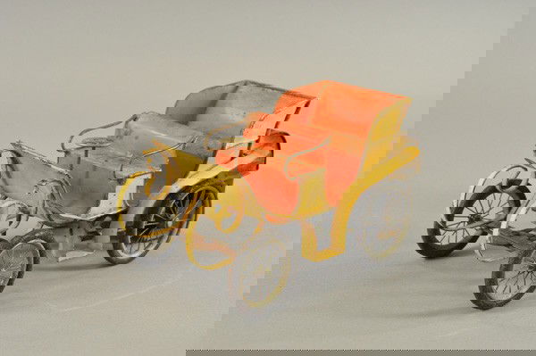 CARETTE STEAM DRIVEN HORSELESS CARRIAGE: Germany, early 1900's, hand painted tin, done in yellow body, red interior, steam boiler on rear of auto, spirit lamp fits at opening door, rubber tires, spoke wheels. 11 1/2" l.