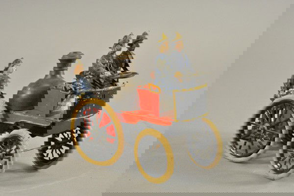 GUNTHERMANN FIRE PUMPER: Germany, c. 1900, hand painted tin, done in red open body containing boiler and fireman standing on rear platform, rubber tires on spoke wheels, clockwork mechanism, very rare example. 8 1/4" l.