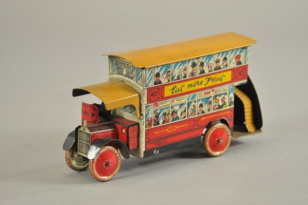 ENGLISH CITY BUS: England, c.1930's, disc wheels read "British Made Smith & Cavey," lithographed tin, extensive graphic imagery, sides read "Drink More Milk," seated driver. 8 1/4" l.