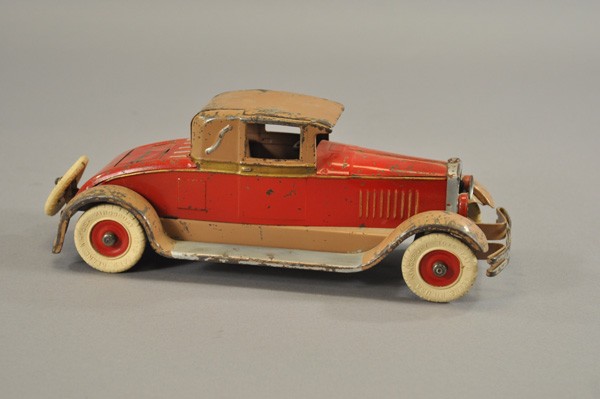 KINGSBURY COUPE: 1927, pressed steel, 344 series, done in red and tan body and fenders, opening rumble seat, clockwork driven, spare on trunk, white rubber tires. 12 3/4" l.