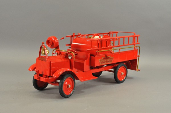 KEYSTONE PACKARD CHEMICAL PUMP ENGINE: c. 1926, pressed steel, painted in red overall, low open cab and service body, features side mounted ladders, water tank and hose reel, rubber tires, disc wheels, railed rear platform. 27" l.