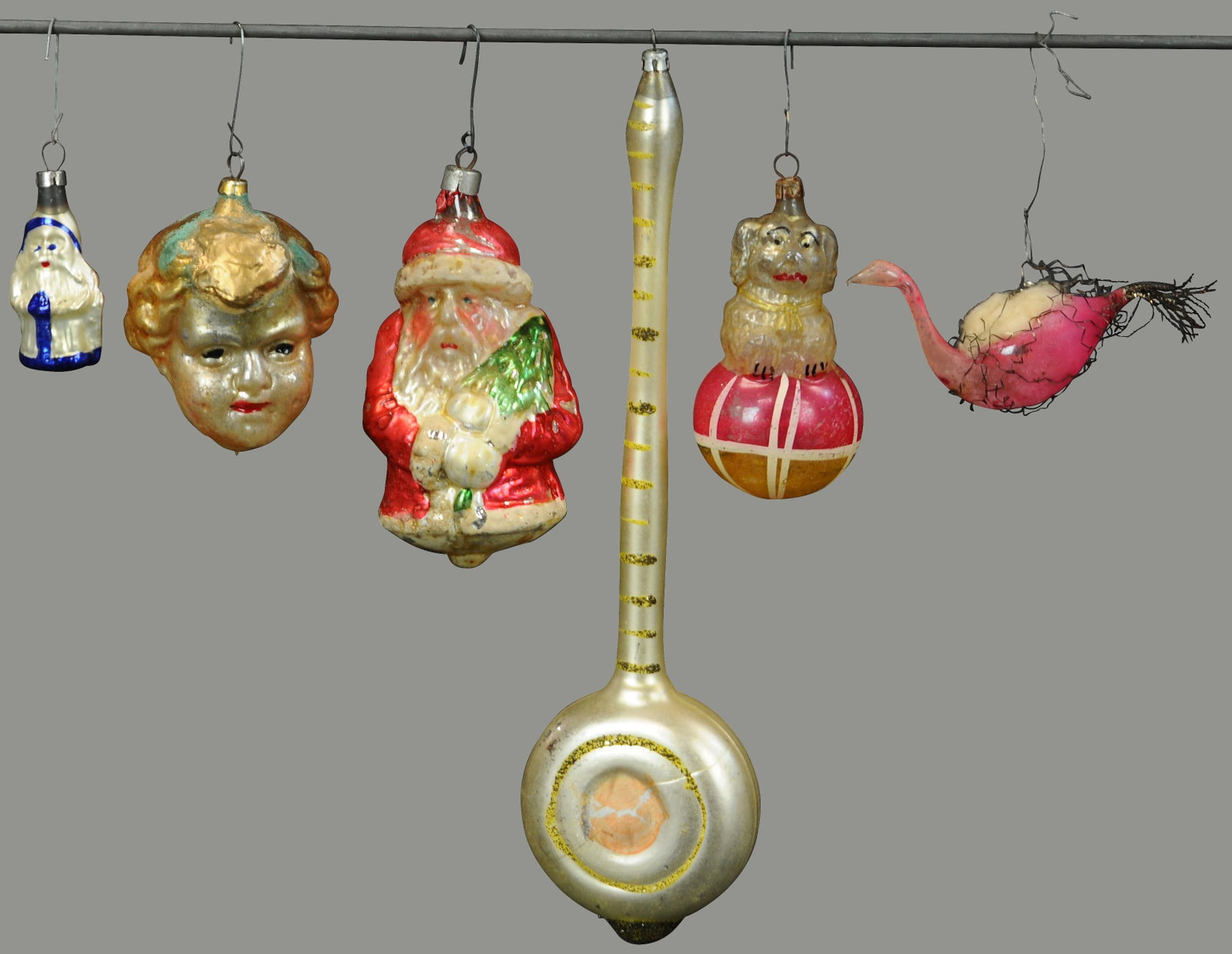 ASSORTMENT OF SIX HARD TO FIND GLASS ORNAMENTS: 91. ASSORTMENT OF SIX HARD TO FIND GLASS ORNAMENTS | A great looking Santa w/tree, golden hair girl, and others. | 2" h. - 10" h. | (Exc. Cond.) | $200 - $400