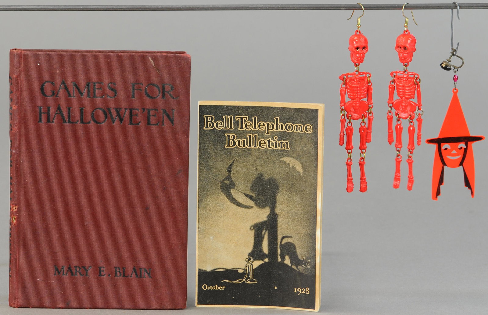 GAMES FOR HALLOWEEN BOOK & ASSORTED NOVELTIES: 174. GAMES FOR HALLOWEEN BOOK & ASSORTED NOVELTIES | Plastic party favors, a Bell phone leaflet and a "Mary E. Blain" Halloween games book. | Book 7" h., Novelties 2" h. -3" h. | (VG Cond.) | $50 - $1