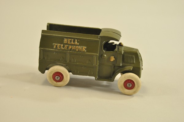 BELL TELEPHONE TRUCK: Hubley, cast iron, Mack "C" cab, painted olive green, embossed on sides of open top body, rubber tires, cast driver. 5 3/8" l.
