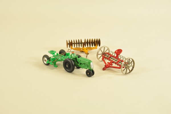 FARM TRACTOR AND IMPLEMENTS: Cast iron grouping, includes small tractor with corn planter, disc plow, and hay rake, varied colors. 4 1/2"-7 1/2" l.