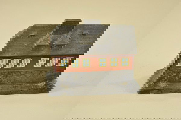 GERMAN COUNTRY HOME LEAD STILL BANK: Well detailed overall, a barn styled building, door cast on side, center chimney holds coin slot, key lock trap. 4 3/4" h. x 6 1/4" w.