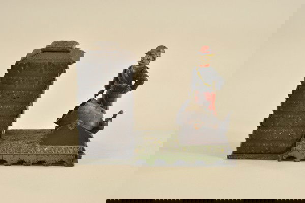 ARTILLERY MECHANICAL BANK: J & E Stevens Co., designed by Peter Adams, circa 1900. The coin is placed in the cannon. The hammer is then pushed back; when the thumb piece is pressed upon; the coin is fired into the fort or tower