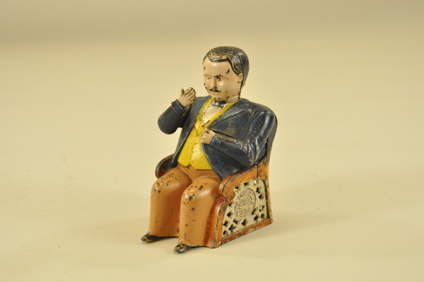 TAMMANY MECHANICAL BANK: Brown pants, J & E Stevens Co., designed by John D. Hall, patented 12/23/1873. Put a coin in his hand, and see how promptly he pockets it, and how politely he bows his thanks.