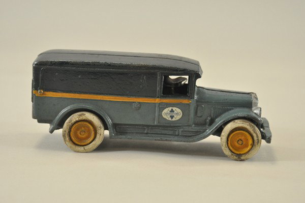 1932 INTERNATIONAL DELIVERY TRUCK: Arcade, cast iron, painted in blues w/orange side stripes, rubber tires, nickeled driver, nice international decals on doors. 9 1/2" l.