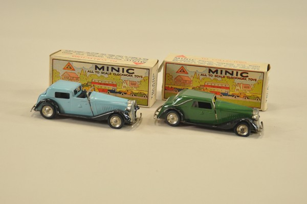 TWO TRI-ANG MINIC AUTOS: Boxed, England, includes Town Car and Cabriolet, both tin with clockwork mechanism, one done in blue, one in green, both have black fenders. 5" l.