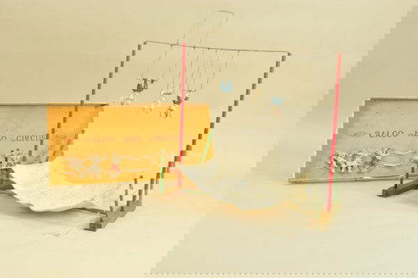 CALCO "AZO" CIRCUS TOY: Interesting cast iron and wood circus toy, performers hang on wire bars, drop net canvas mounted to wood frame, includes bottom of box and original stringing for figures. 17" w. x 18" w. assembled.