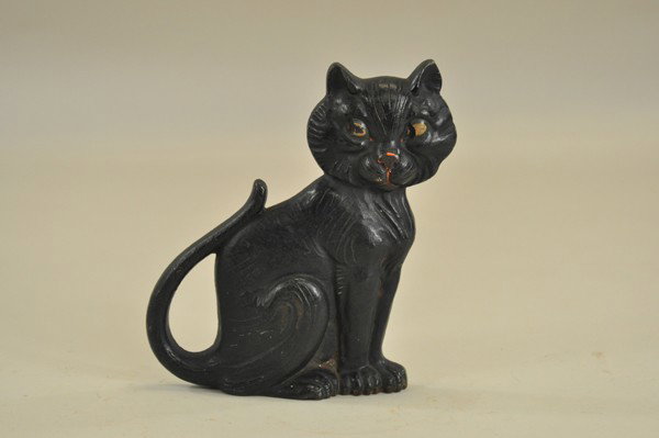SITTING BLACK CAT DOORSTOP: Marked "AM ° Greenblatt Studio copyright 1927 #20," wedge back design, features black shifty-eyed cat with curiously posed tail. 7" x 9"