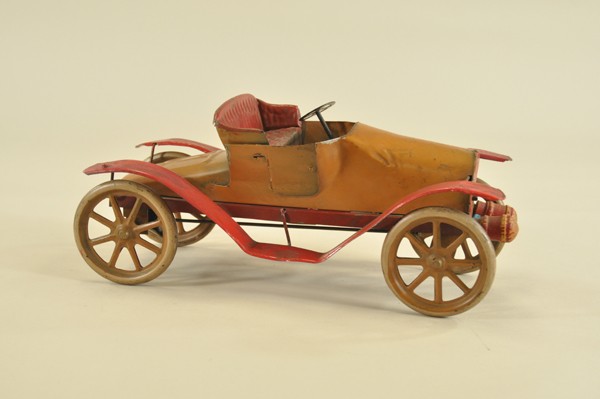 CONVERSE RUNABOUT: Rare early example, c. 1910, pressed steel, painted in brown body, red fenders, large spoke wheels, embossed open seating. 15" l.