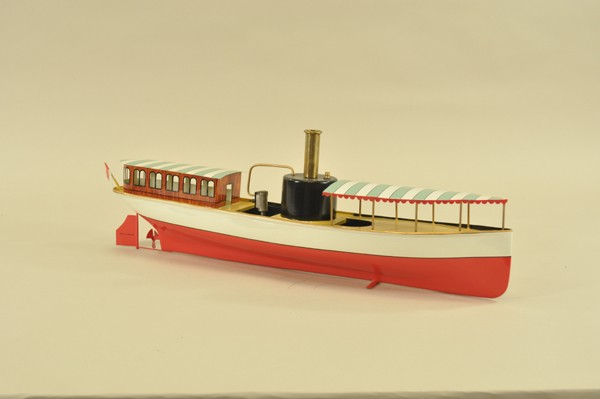 SCHOENNER STEAM LAUNCH: Early 1900's, hand painted tin, canopy covers complete bow sections, covered cabin at stern, boiler and brass stack at center. 22" l.