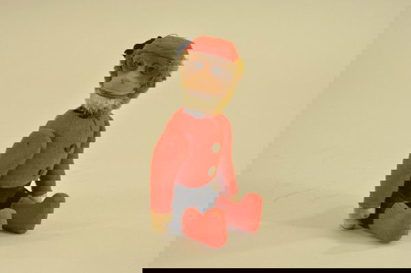 SCHUCO YES/NO MONKEY: Germany, felt outfit, depicted as bell hop, tin body contains gear allowing head to shake in yes or no poses. 8 1/2" standing.