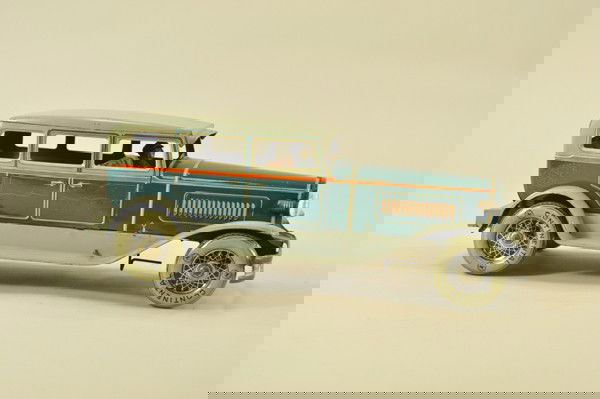 KARL BUB AUTO: Germany, lithographed tin, green body, grey roof, seated driver, electric lights, clockwork mechanism, beautiful lines, logo on grille dates this example to the 1930's. 14" l.