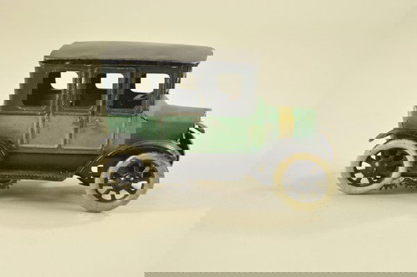 OROBR MODEL "T" FORD: Germany, lithographed tin, green body with gold bonnet band, opening doors, clockwork driven, spoke wheels. 6" l.