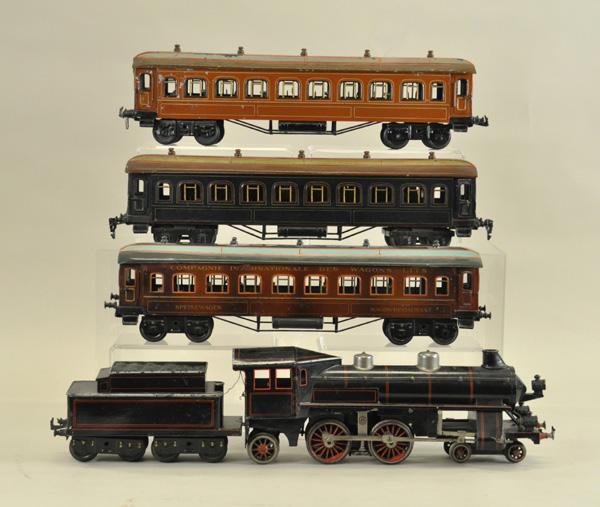 BING WIND CUTTER TRAIN SET: Germany, gauge "1", features the impressive 4-4-2 wind cutter in black, red and silver trim with eight wheel tender, together with sleeping car and two dining cars, one stenciled on side. Loco 15" l.,