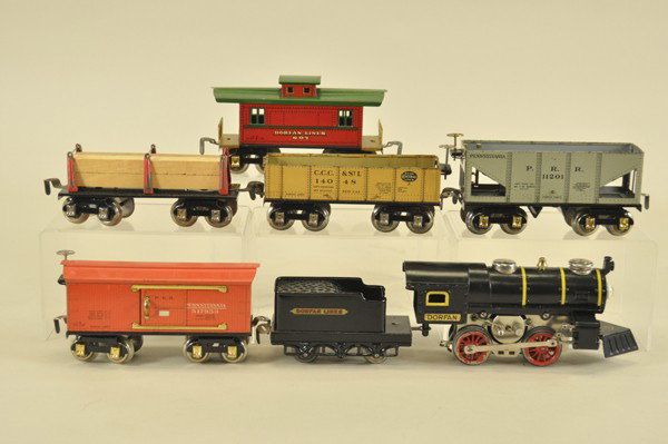 DORFAN "O" GAUGE FREIGHT SET: American steam profile 0-4-0, electric powered engine, together with tender and five cars including, box car, lumber car, hopper, gondolas, and caboose, all in lithographed tin. Cars 6 1/4" l.