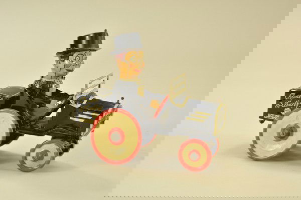 CHARLIE MCCARTHY BENZINE MOBILE: Louis Marx, lithographed tin, features Charlie seated in open black and white auto, clockwork mechanism, head spins as car rolls through wacky motions. 7 1/2" l.